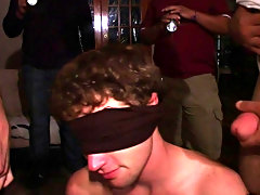 These frat boys had their pledge blind folded on his knees while two brothers one with a shirt that said fuck and the other with a shirt that said suc